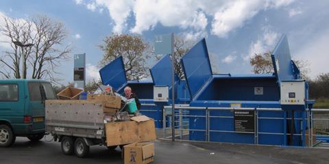 blue recycling bins at a recycling center