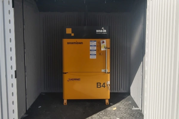 yellow baler in outdoor shed