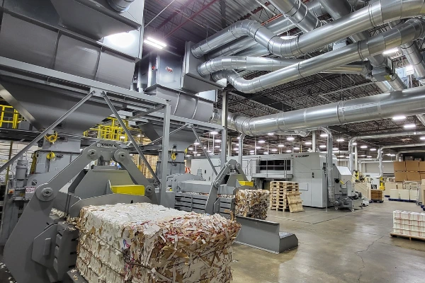 bales and ductwork in front of bobst machine and shredder
