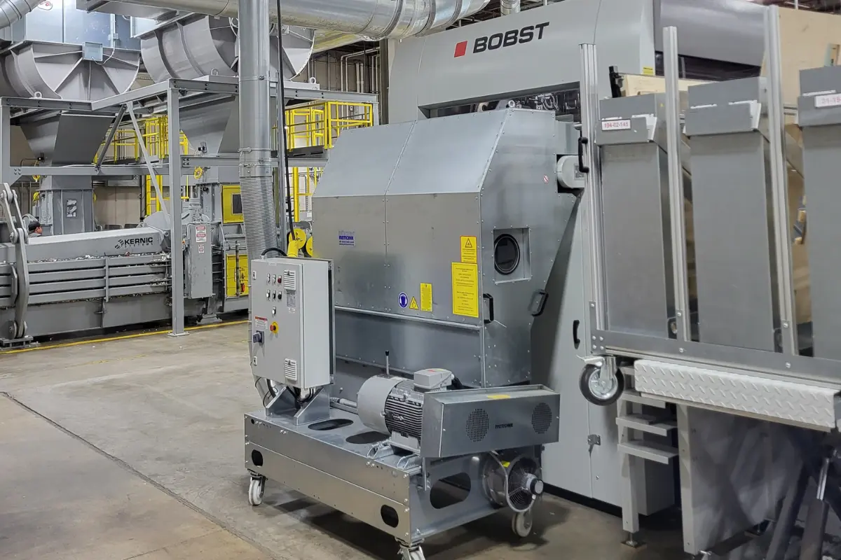 silver blanking shredder with bobst die cutter and balers in background